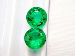 two green round cut lab emeralds 3.49 carats