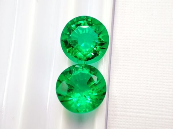 two green round cut lab emeralds 3.49 carats