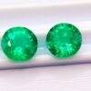 two green round cut lab emeralds 3.49 carats