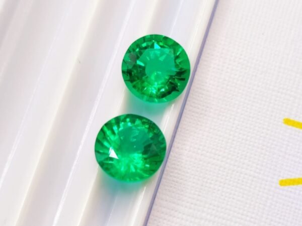 two green round cut lab emeralds 3.49 carats