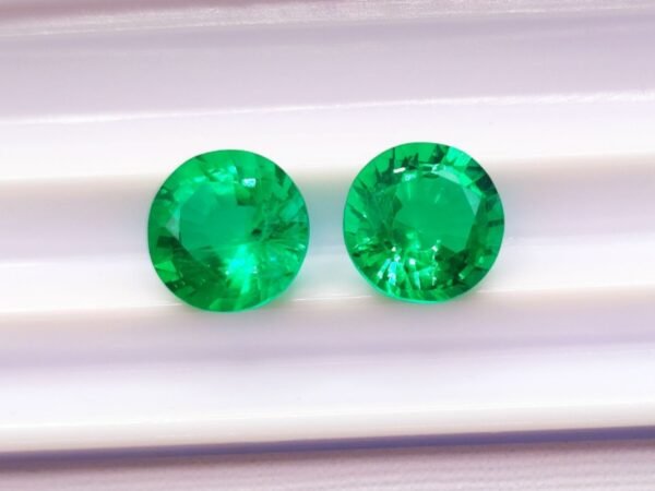 two green round cut lab emeralds 3.49 carats