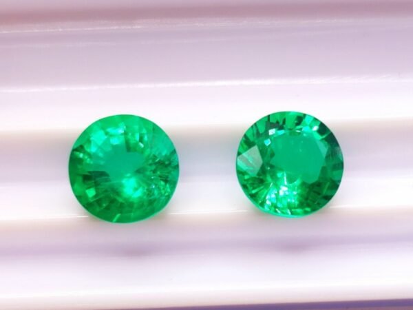 two green round cut lab emeralds 3.49 carats
